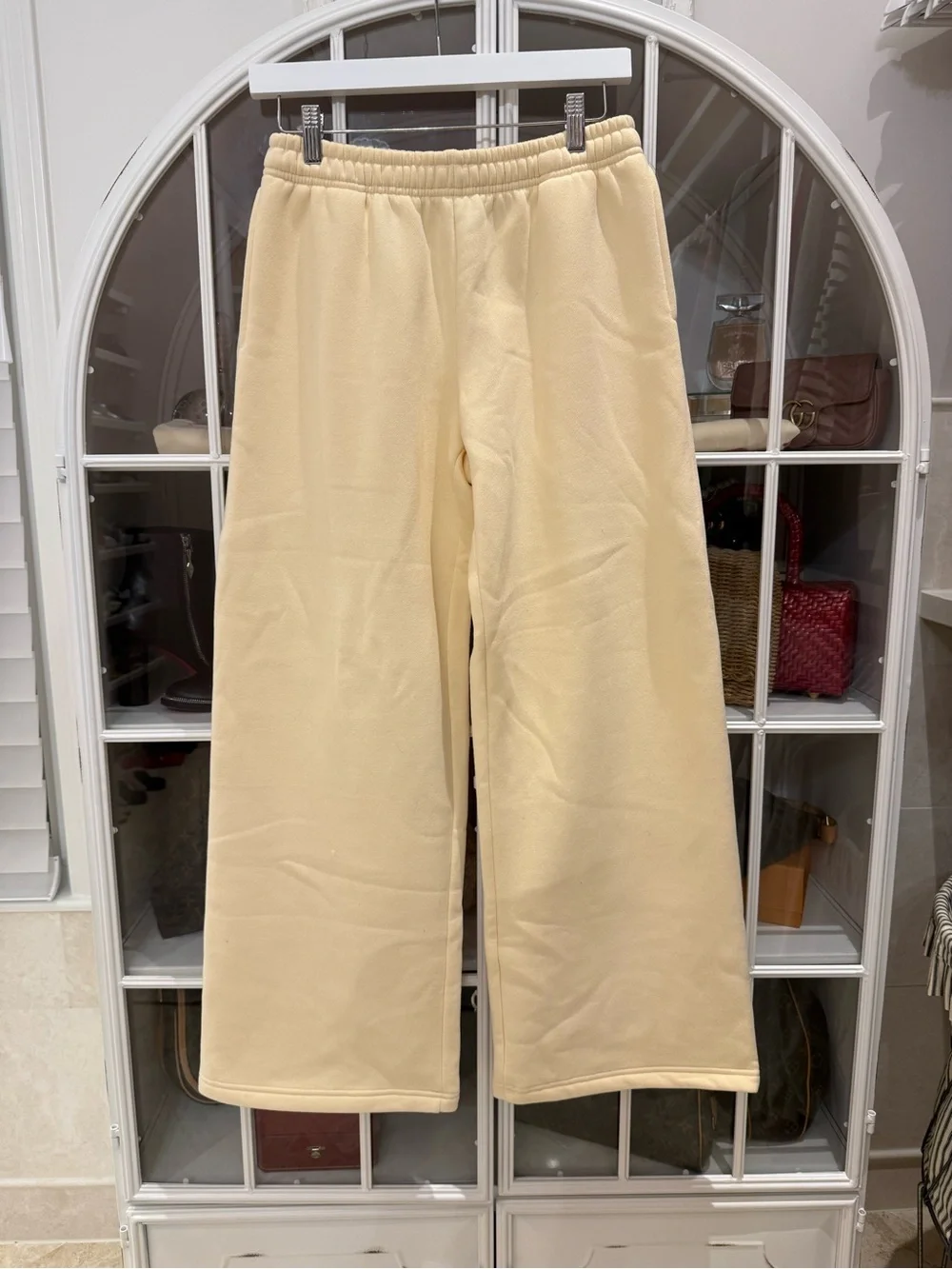 Edikted Cream/Light YellowTrack Pants with Pink Bow Detail on back of pants.